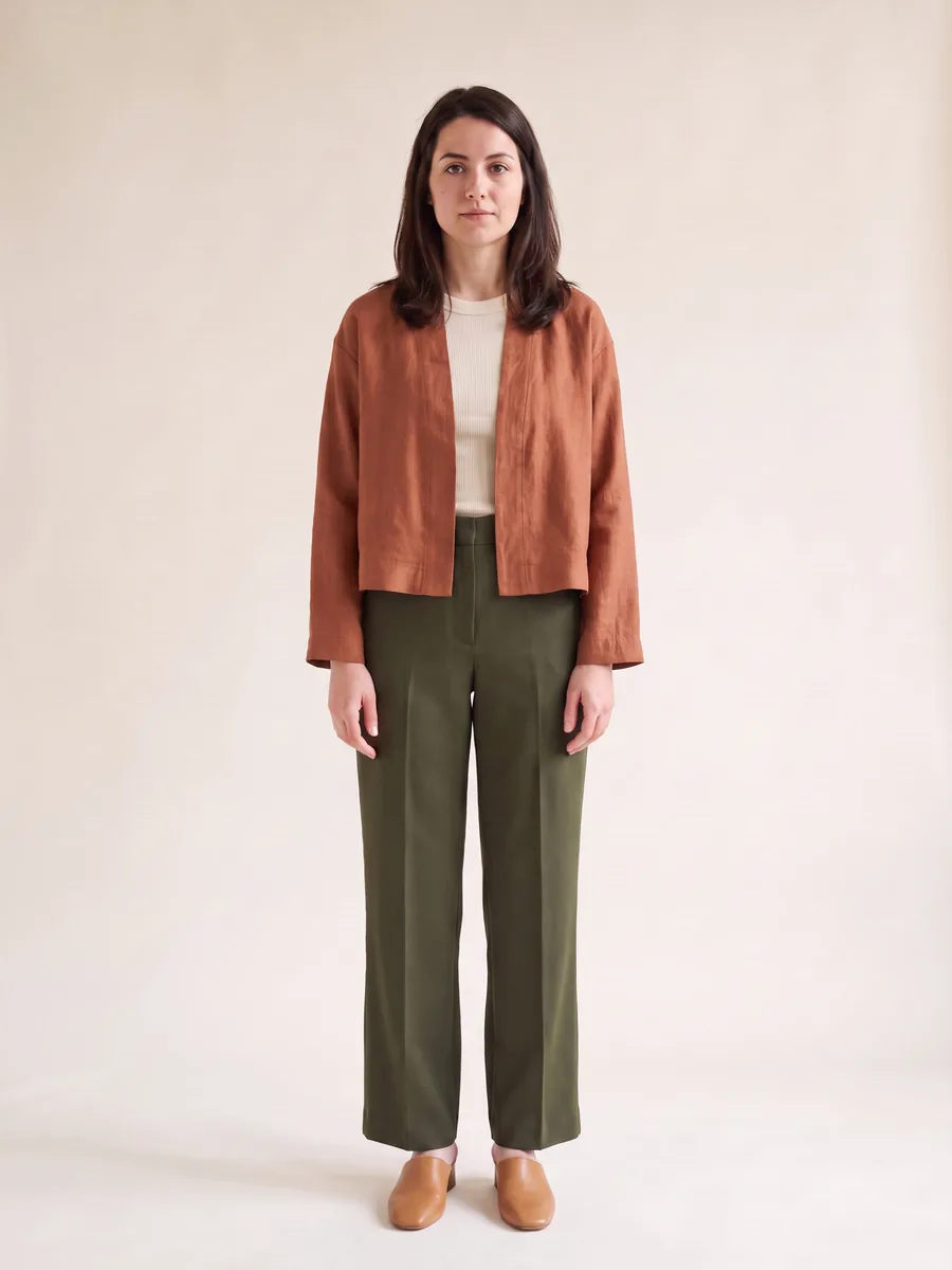 The shopper wearing the cropped linen jacket over a ribbed knit tank with wide-leg trousers